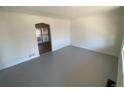 Bright living room features fresh paint and unique arched doorway to other rooms at 945 Zenobia St, Denver, CO 80204