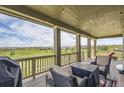 Comfortable covered patio with outdoor seating overlooking the golf course at 7658 S Country Club Pkwy, Aurora, CO 80016