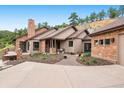 Well-maintained home featuring stone accents, covered porch, and inviting landscaping with a concrete driveway at 21609 Clarence Ln, Golden, CO 80401
