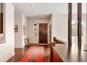Bright foyer features hardwood floors, wooden door and trim, area rug, and modern design elements at 21609 Clarence Ln, Golden, CO 80401