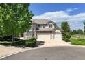 Charming two-story home with stone accents, a three-car garage, and a lush lawn at 9278 E Aspen Hill Pl, Lone Tree, CO 80124