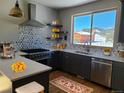 Modern kitchen with stainless steel appliances, stone countertops, and a mountain view at 656 County Road 72, Bailey, CO 80421