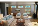 Bright living room featuring large windows, hardwood floors, and comfortable seating at 656 County Road 72, Bailey, CO 80421