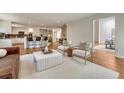 Open-concept living room with eat-in kitchen, hardwood floors, and modern furniture at 5672 S Hanover Way, Greenwood Village, CO 80111