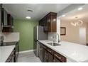 Well-lit kitchen featuring modern appliances, dark wood cabinetry, and white countertops at 800 N Pearl St # 611, Denver, CO 80203