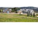 Wide angle view of expansive property with modern luxury home and barn in a meadow setting at 9356 Cherrywood Trl, Littleton, CO 80127