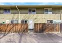 Up close view of exterior unit entrance featuring a privacy fence and vertical wood paneling at 9925 W 20Th Ave # 17, Lakewood, CO 80215
