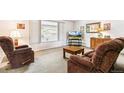 Comfortable living room with plush armchairs, neutral carpet, and natural light from the large window at 7503 Saulsbury St, Arvada, CO 80003