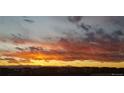 Striking sunset view over the houses and mountains, creating a picturesque and serene backdrop at 9479 Rifle St, Commerce City, CO 80022