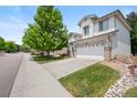 Well-maintained two-story home with a two-car garage, landscaping, and a tidy lawn at 10681 Cherrybrook Cir, Highlands Ranch, CO 80126