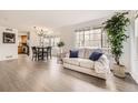 Bright living room with hardwood floors, large windows, and contemporary furnishings at 14245 Corrine Ct, Broomfield, CO 80023