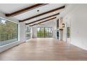 Bright living room with exposed wood beams, large windows, and a fireplace, perfect for relaxation at 2665 Juilliard St, Boulder, CO 80305