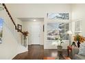 Bright entryway with hardwood floors and staircase at 8845 Jackdaw St, Littleton, CO 80126