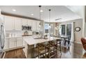 Bright, modern kitchen with a large island, stainless steel appliances, and stylish pendant lighting at 17806 Coral Burst St, Parker, CO 80134