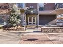 Inviting building entrance features an awning and well-maintained landscaping, enhancing curb appeal at 1150 Vine St # 201, Denver, CO 80206