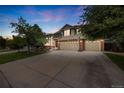 Charming two-story home with a well-maintained lawn, mature trees, and a spacious three-car garage at 2753 E 139Th Dr, Thornton, CO 80602