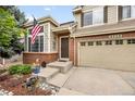 Inviting front entrance with brick accents, a charming front door, and a meticulously landscaped garden at 2753 E 139Th Dr, Thornton, CO 80602