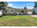 Attractive single-story home showcasing stone and siding details, plus a neat front yard at 2260 S Lewiston St, Aurora, CO 80013