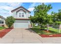 Charming two-story home with lush lawn, mature trees, and a two-car garage at 11355 Haswell Dr, Parker, CO 80134
