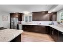 This bright kitchen offers modern cabinetry, granite countertops, stainless appliances and sleek wood flooring at 11355 Haswell Dr, Parker, CO 80134