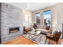 Modern living room featuring a fireplace and hardwood floors at 2438 Welton St, Denver, CO 80205