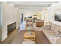Open living space featuring fireplace, open floorplan, and access to balcony at 2401 S Gaylord St # 206, Denver, CO 80210