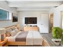 Bedroom featuring modern furnishings, large window, and adjoining bathroom at 2401 S Gaylord St # 206, Denver, CO 80210