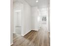 Light and airy hallway with light hardwood floors and white walls at 1975 S Coolidge Way, Aurora, CO 80018