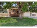 Charming home featuring a well-manicured lawn, mature shade tree, and inviting front porch at 3838 S Waco St, Aurora, CO 80013