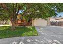 Charming home featuring a well-manicured lawn, mature shade tree, and inviting front porch at 3838 S Waco St, Aurora, CO 80013