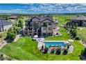 Expansive backyard featuring a swimming pool, patio with outdoor seating, and well-manicured lawn at 7343 Upton Ct, Castle Rock, CO 80104