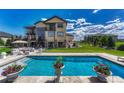 Inviting backyard pool area with comfortable lounge furniture, patio, and lush landscaping at 7343 Upton Ct, Castle Rock, CO 80104