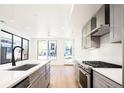 Open concept kitchen with stainless steel appliances, gray cabinets, and a quartz countertop island at 263 S Jackson St, Denver, CO 80209