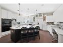 Modern kitchen with a large island, black appliances, and open layout perfect for entertaining at 7081 Salvia St, Arvada, CO 80007