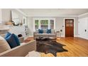 Bright living room featuring hardwood floors, fireplace, and large windows offering natural light at 766 Monroe St, Denver, CO 80206