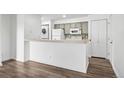 Bright kitchen features a breakfast bar and a washing machine at 4899 S Dudley St # 7E, Littleton, CO 80123