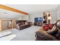 Inviting living area with plush seating, a beamed ceiling, and an open layout at 9655 W 105Th Way, Broomfield, CO 80021