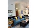 Inviting living room with vaulted ceilings, stylish decor, and an open layout at 9610 W Chatfield Ave # F, Littleton, CO 80128