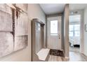 Welcoming entryway featuring a bench with coat hooks and decorative painting at 39167 Braxton Ln, Elizabeth, CO 80107