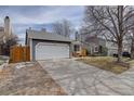 Beautiful home with a long driveway, two-car garage, and manicured front yard at 4542 S Quintero St, Aurora, CO 80015