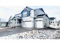 Attractive two-story home with a three-car garage and a welcoming front porch, complemented by snow-covered landscaping at 39887 Floyd St, Elizabeth, CO 80107