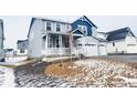 Inviting two-story home boasting a spacious three-car garage, a cozy front porch, and beautifully landscaped yard at 39887 Floyd St, Elizabeth, CO 80107