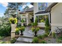 Elegant entryway with stone flooring and lush landscaping at 918 Dakota Dr, Castle Rock, CO 80108