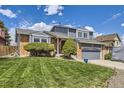 Charming home featuring a lush front lawn, complemented by mature landscaping and a partial driveway view at 3680 S Gibralter Cir, Aurora, CO 80013