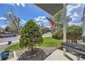 View from the covered front porch with landscaping and an American flag on display at 3680 S Gibralter Cir, Aurora, CO 80013