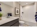 Well-lit bathroom with a modern vanity, a bathtub, and white tiled walls at 903 W Beverly St, Elizabeth, CO 80107