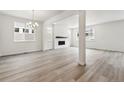 Open-concept living room with hardwood floors and modern fireplace at 9266 Telluride Ct, Commerce City, CO 80022