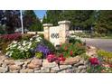 Stone monument displaying '4545' address with colorful flowerbeds at 4545 S Monaco St # 243, Denver, CO 80237