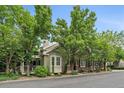 Inviting home exterior showcasing a cozy porch, bay window, and mature trees at 4545 S Monaco St # 243, Denver, CO 80237