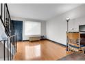 Bright living room featuring hardwood floors and a contemporary design with blue trim at 8915 Field St # 116, Broomfield, CO 80021
